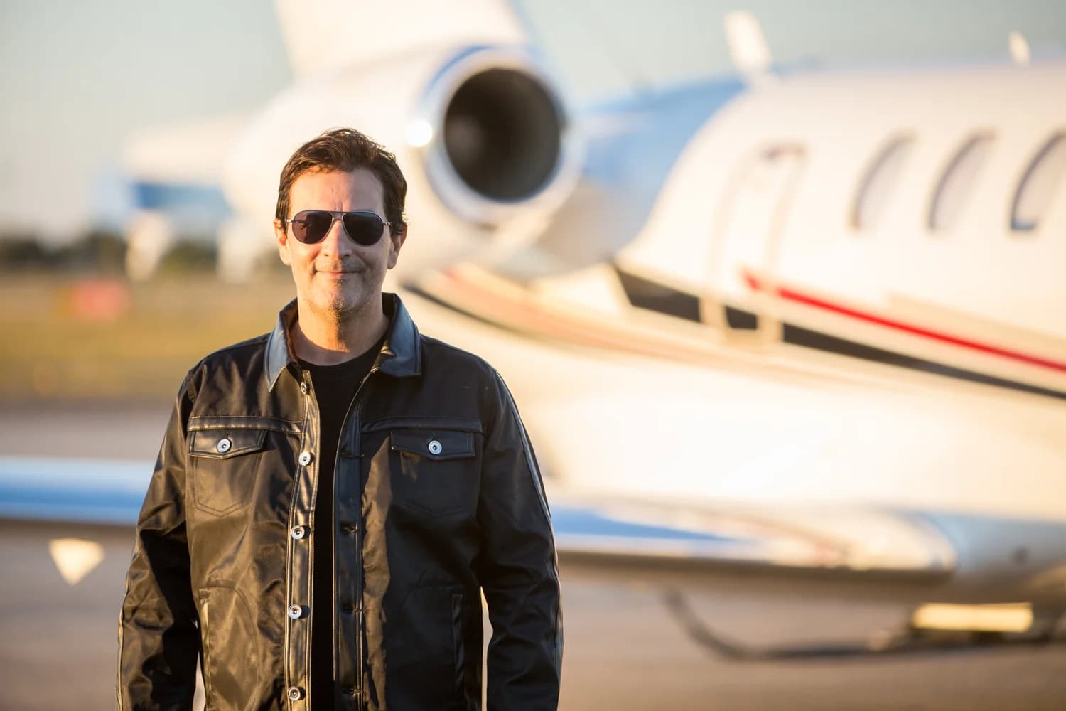 Harry Hedaya on the ramp beside a jet